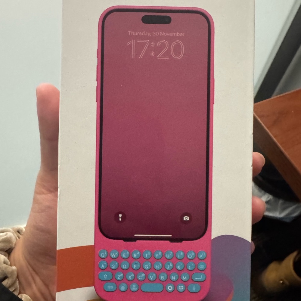 Pink Smartphone with Blue Keyboard Case

Clicks I phone 15 pro max case and box
